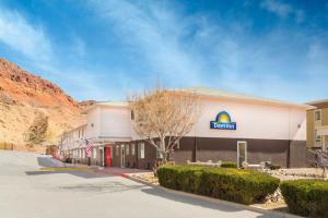 a hotel with a sign on the side of a building at Days Inn by Wyndham Moab in Moab