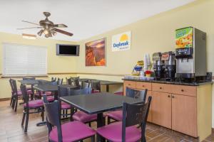 a dining room with tables and purple chairs at Days Inn by Wyndham Moab in Moab