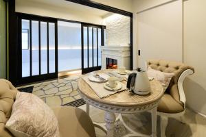 a living room with a table and a fireplace at Guest Villa Hakone Yumoto 101 in Hakone