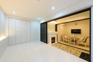 a living room with a fireplace and a table at Guest Villa Hakone Yumoto 101 in Hakone