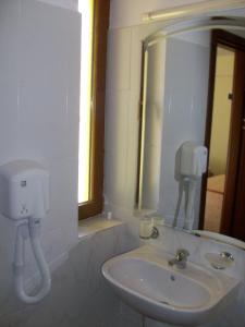 a bathroom with a sink and a mirror at Hotel Angely in Eforie Nord +13 photos