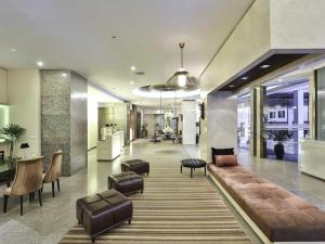 a lobby with couches and chairs and a table at Sunbeam Hotel Pattaya - SHA Extra Plus in Pattaya