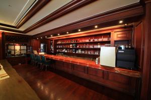 a bar in a restaurant with a lot of wine bottles at Asia Lakeside Hotel in Jinju