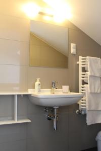 a bathroom with a sink and a mirror and towels at Villa Stella Baltica in Władysławowo +25 photos