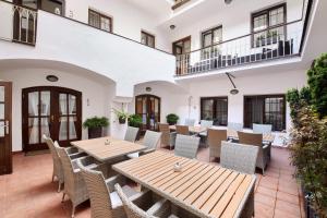 an outdoor patio with wooden tables and chairs at Old Prague House in Prague