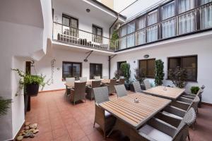 a patio with tables and chairs in a building at Old Prague House in Prague