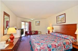 a hotel room with a bed and a table at America's Best Value Inn of Novato in Novato