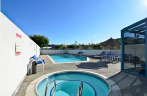 a large swimming pool next to a building at America's Best Value Inn of Novato in Novato