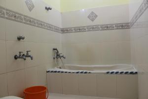a bath tub in a bathroom with a toilet at Hotel Sea View Palace - the beach hotel in Kovalam