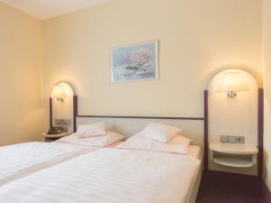 Stadt-gut-Hotel Siegboot tesisinde bir odada yatak veya yataklar