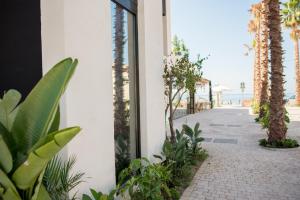 a building with palm trees and a walkway at H Boutique Peña Parda in La Herradura