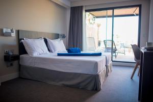 a hotel room with a bed with a view of a patio at H Boutique Peña Parda in La Herradura