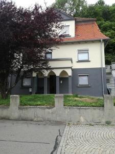 a white house with a red roof at Ferienwohnung Epple in Bad Urach