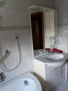 a bathroom with a sink and a toilet and a mirror at Haus Forstamt in Stadtsteinach +32 photos