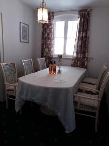 a dining room with a table with chairs and a window at Haus Forstamt in Stadtsteinach