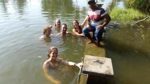 a group of people are in the water at Priyanna Guest, Forest view in Polonnaruwa