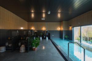 a large swimming pool in a building with a pool at Hotel Route-Inn Kashima in Kashima