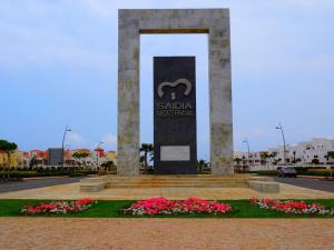 a monument in the middle of a park with flowers at Appart Clim Wifi 700m de la Plage in Saïdia