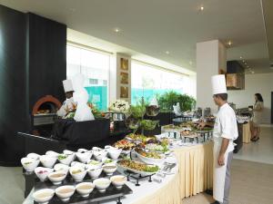 a buffet of food with chefs standing in front of it at The Zuri Whitefield Bengaluru in Bangalore