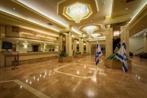 a lobby of a hotel with flags on the floor at Shalom Jerusalem Hotel in Jerusalem