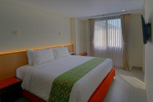 Postel nebo postele na pokoji v ubytování Savvoya Hotel Seminyak