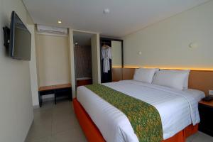 Postel nebo postele na pokoji v ubytování Savvoya Hotel Seminyak