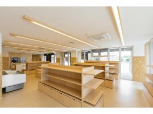 an empty office with wooden dividers in a room at Hotel Higashimokoto in Abashiri