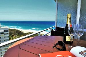 una botella de vino sentada en una mesa con copas de vino en Equinox Resort, en Gold Coast