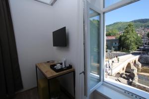a room with a window with a view of the coliseum at Riverside Residence in Sarajevo