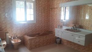 a bathroom with a tub and a toilet and a sink at Clos de l'Artuby in Valderoure +22 photos