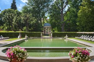 a pool in a garden with a gazebo at Four Seasons Hotel Firenze in Florence