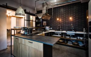 a large kitchen with a counter top in a room at Teku Sardinia Boutique Hotel in Bari Sardo