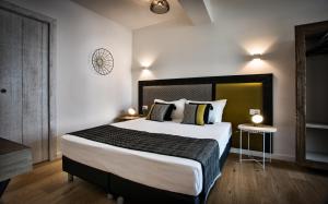 a bedroom with a large bed in a room at Teku Sardinia Boutique Hotel in Bari Sardo