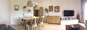 a living room with a dining room table and a tv at Madre Mia Apartment in Casares