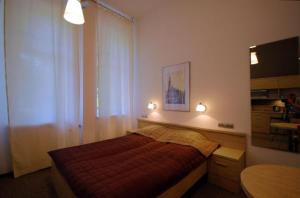 a bedroom with a bed with two lights on it at Platinium Centrum in Wrocław