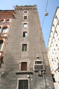 a building with a clock on the side of it at Residenza Torre Colonna in Rome
