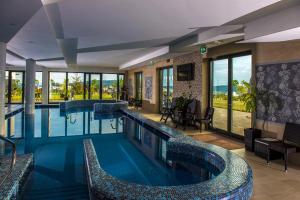 a pool in a hotel with a view at Castellum Hotel Hollókő in Hollókő