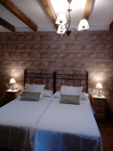 a bedroom with a large bed and two night stands at La Esquina de Animas in La Alberca