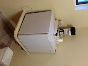 a toilet paper dispenser on the wall of a bathroom at Snowy River Inn in Show Low