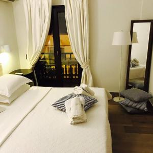 a hotel room with two towels on a bed at Afroditi Arhontiko in Litochoro