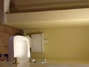 a bathroom with a sink and a paper towel dispenser at Snowy River Inn in Show Low +9 photos