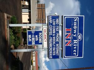 a group of blue signs hanging from a building at Snowy River Inn in Show Low