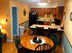 a kitchen and dining room with a table and chairs at Nordic Condo in Lincoln