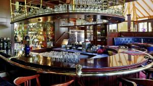 a bar in a restaurant with glasses on the counter at Parkhotel Stader Hof in Stade