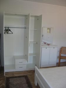 a bedroom with white cabinets and a bed at Apartment Kovacic Jurlina in Poljica