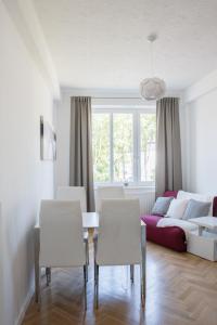 a living room with a table and chairs and a couch at Apartment Nearto Old Town Na Ustroniu street in Krakow