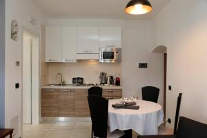 a kitchen with a table with chairs and a microwave at Residence Sugrac in Valpicetto