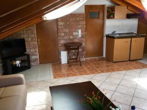 a kitchen and a living room with a table and a stove at Karagiannaki in Skála Sykaminéas +44 photos