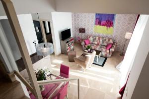 uma vista aérea de uma sala de estar com mobiliário rosa em Singular Metropol em Sevilha