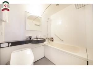 a bathroom with a toilet and a sink and a tub at Richmond Hotel Tokyo Shiba in Tokyo +31 photos